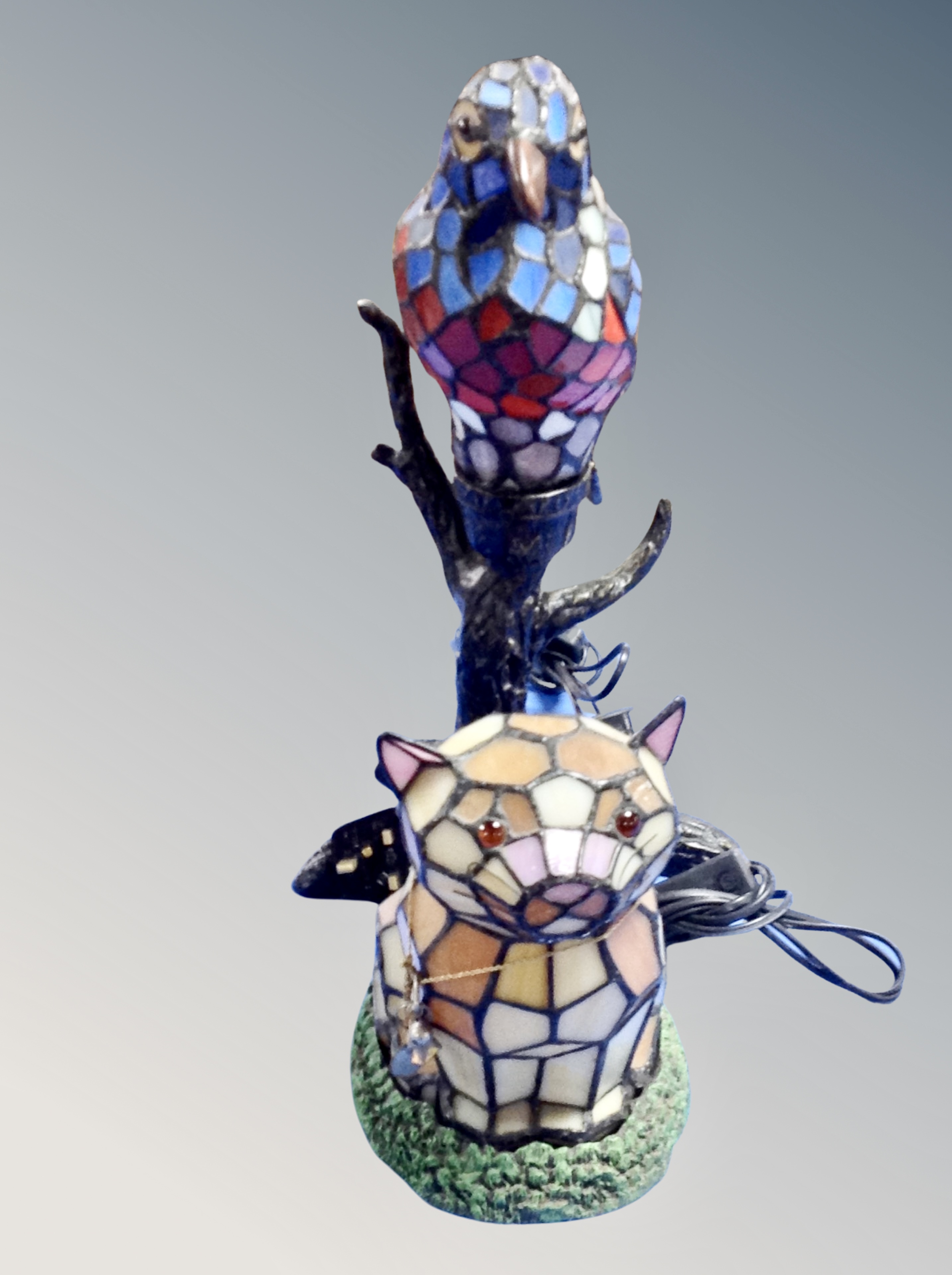A contemporary leaded glass table lamp in the form of a parrot on branch together with a further