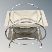 A mid century Swedish chrome serving trolley with smoked glass shelves