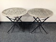 A pair of folding garden tables on metal legs