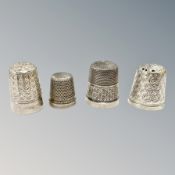 Four silver thimbles