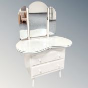 A two drawer kidney shaped dressing table with triple mirror in washed oak finish
