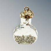 A 9ct gold mounted glass bottle charm