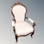 A Victorian carved armchair in pink fabric