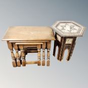 An antique marquetry and mother of pearl inlaid octagonal plant table together with nest of three