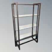 A set of contemporary metal and glass three tier shelves