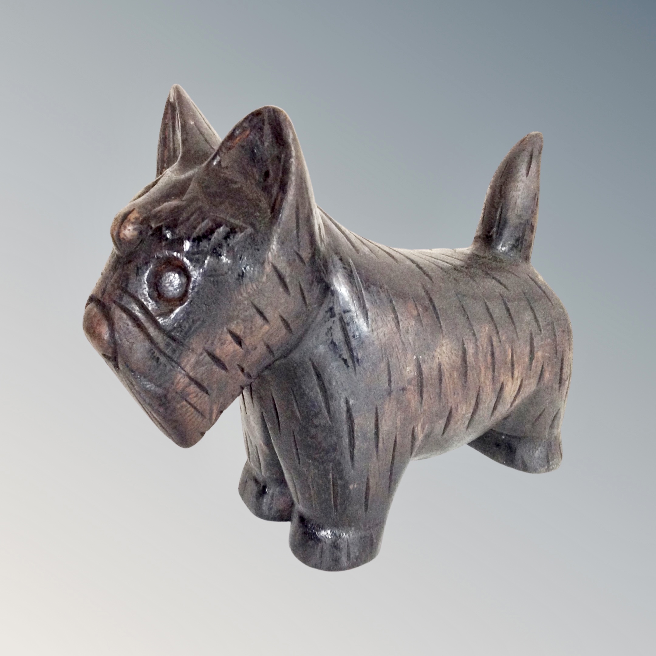 A carved wooden folk art figure of a Scottie dog,