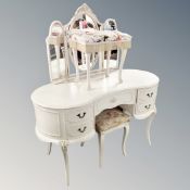 A kidney shaped dressing table with triple mirror and stool together with further dressing table