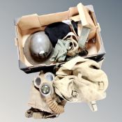 A box of WWII items to include gas mask, tin helmet,