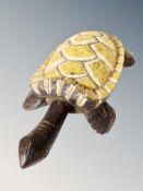 A carved wooden and painted African figuer of a turtle, N.E.