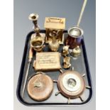 A tray of antique and later brass ornaments and candlesticks, ships wheel barometer,