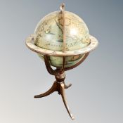 A reproduction terrestrial globe on three-way pedestal, height 125 cm.