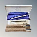 A cased 'Life Long' propelling pencil, stamped 9ct gold, two pens and a Parker ink refill.