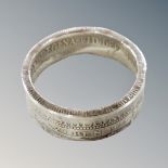 A silver Victorian two shilling piece band ring