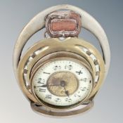 An antique brass clock inset into a horseshoe