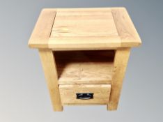 A contemporary oak bedside stand fitted a drawer