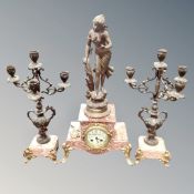 A three piece French rouge marble and spelter figural clock set with hand painted dial on gilt feet,