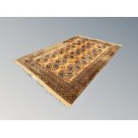 A Bokhara style carpet on cinnamon ground,