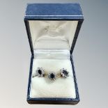 An 18ct gold sapphire cluster ring, size L, and similar pair of 9ct gold earrings.