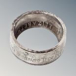A silver Canadian dollar band ring