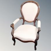 A Victorian style spoon backed armchair in pink fabric