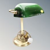 A brass banker's lamp with green glass shade