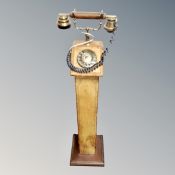 A retro style telephone on leather pedestal