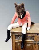 A large fox soft toy in huntsman outfit