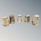 Five silver thimbles