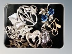 A tin of brooches, including Masj, silver maple leaves, floral,