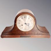 A 20th century oak cased mantel clock with silvered dial