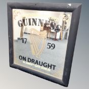 A Guinness on draught hand painted advertising mirror, framed.