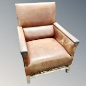 A contemporary tan buttoned armchair