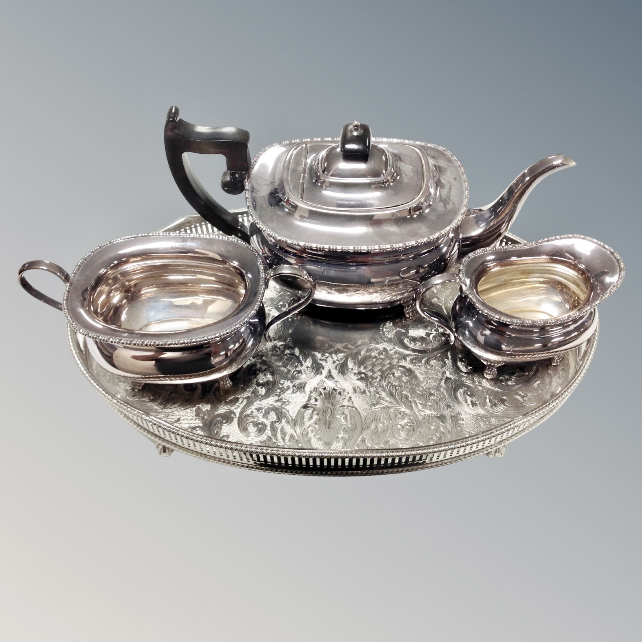 A three piece Viners plated tea service on gallery tray (4)