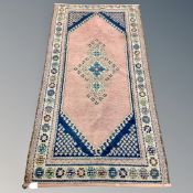 A woolen hand knotted carpet 165 cm x 84 cm