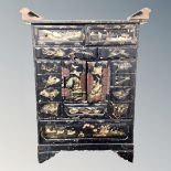 An early 20th century Japanese export black lacquered table cabinet fitted with drawers