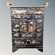 An early 20th century Japanese export black lacquered table cabinet fitted with drawers