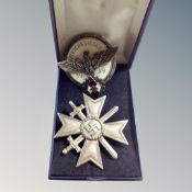 A German WW II Merit of Cross first class badge together with a further Hitler Youth 1939 enamelled