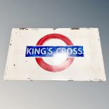 An enamelled metal panel with hand painted Kings Cross Underground emblem,