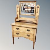 An oak Arts and Crafts two drawer dressing chest