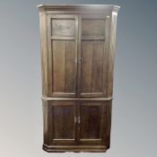 A 19th century oak double corner cabinet