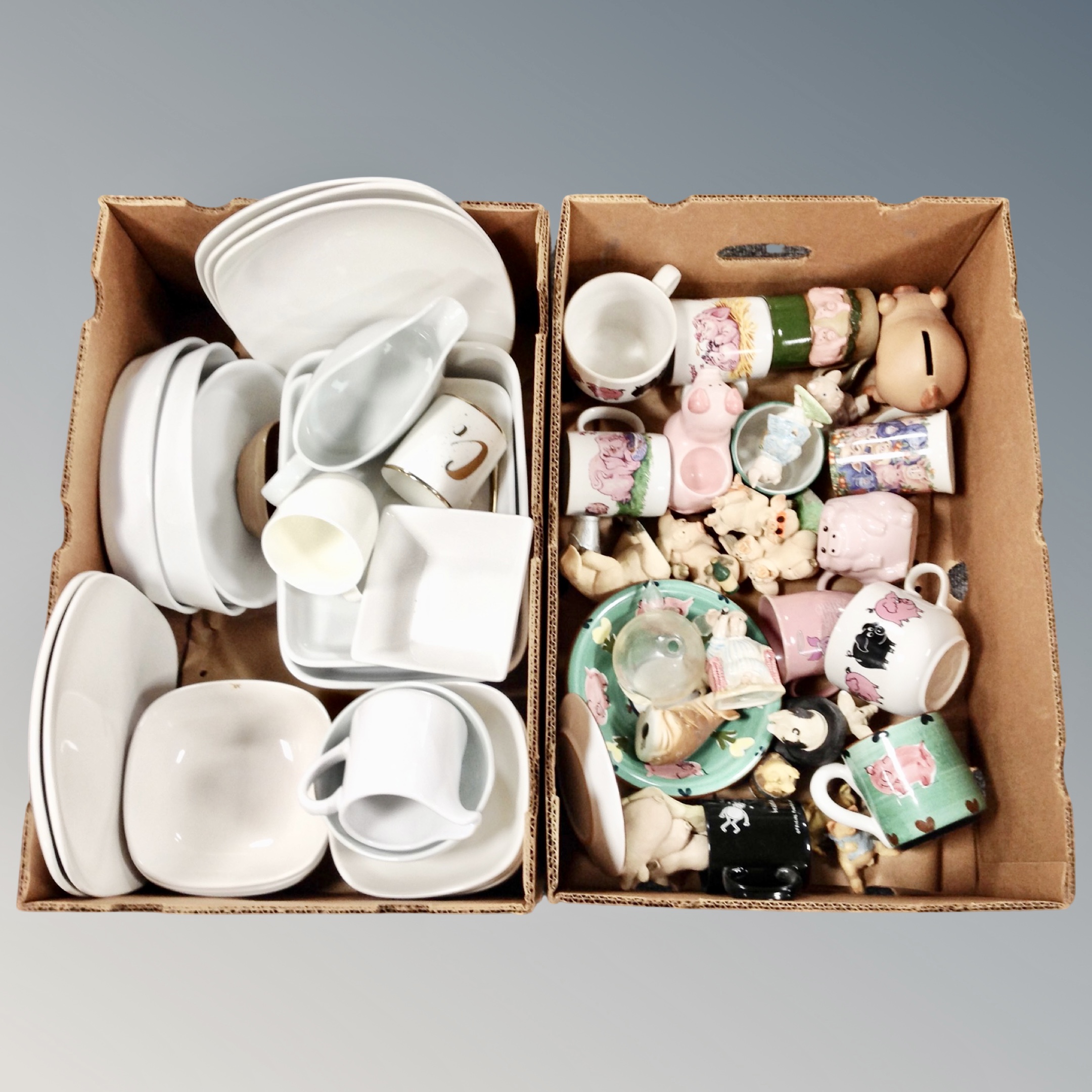 Two boxes of white dinner ware, pig ornaments and mugs,