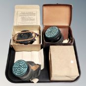 Three WW II era gas masks in boxes