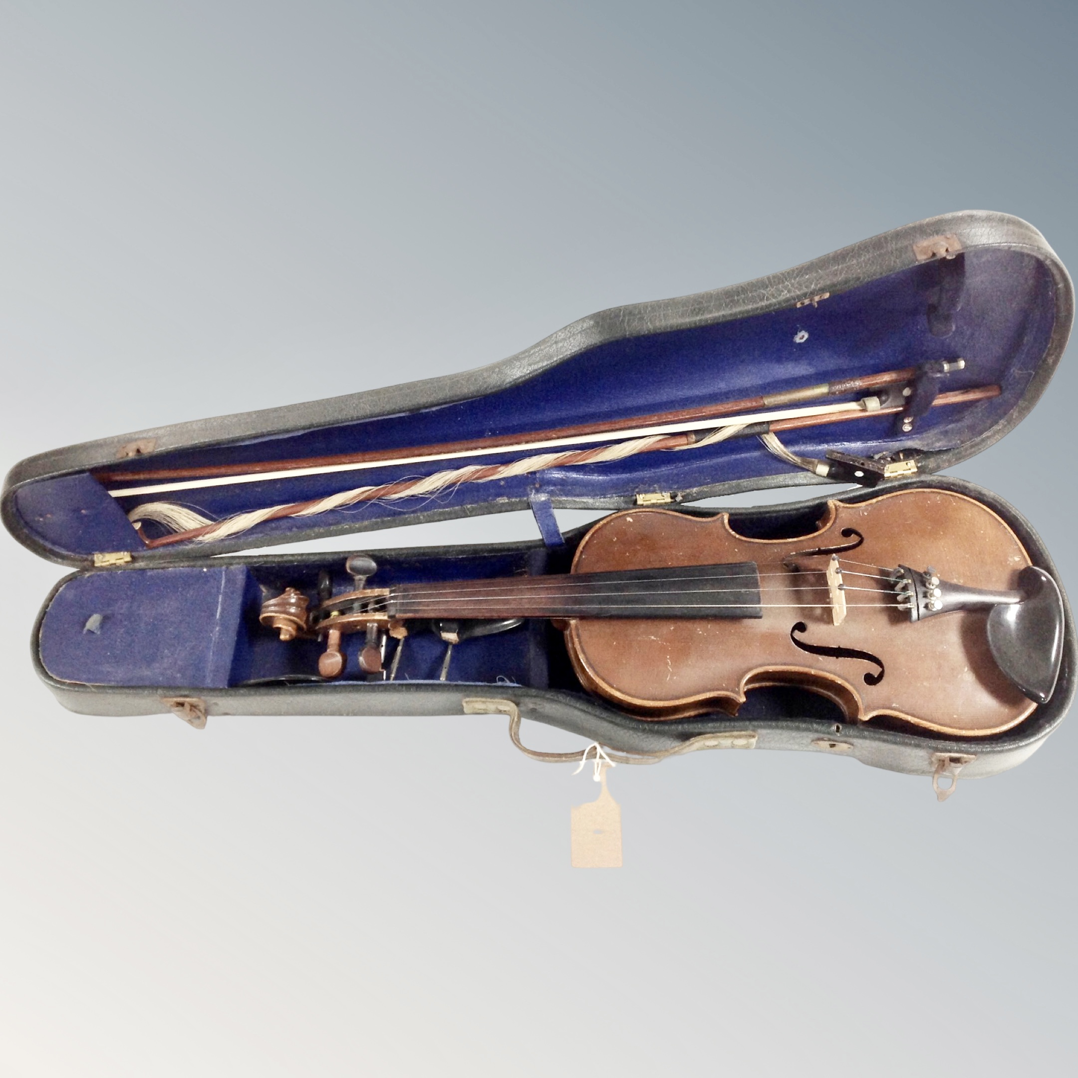 An antique violin with two bows in coffin case
