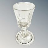 An antique drinking glass with slice cut optics and folded foot, height 4.
