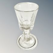 An antique drinking glass with slice cut optics and folded foot, height 4.