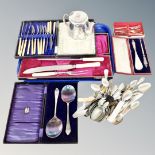 A tray of plated tea pot, boxed and unboxed cutlery, servers,