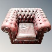 A Chesterfield buttoned club armchair in burgundy leather