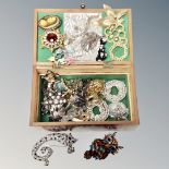 A wooden jewellery box of vintage and later costume brooches