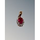 A ruby and diamond silver pendant
