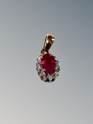 A ruby and diamond silver pendant